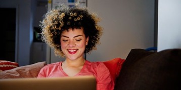 Women working on a laptop on the couch